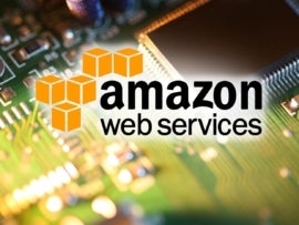 Amazon Web Services logo over processor chip on circuit board.