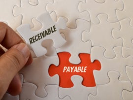 Jigsaw puzzle with text RECEIVABLE and PAYABLE.
